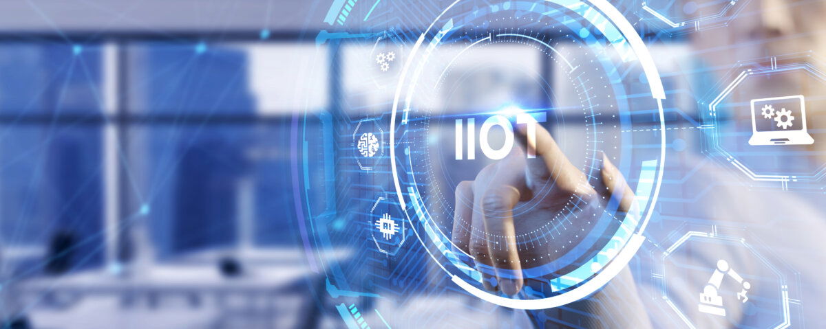 Digital interface showing a person interacting with a virtual screen labeled 'IIoT' (Industrial Internet of Things), surrounded by futuristic icons representing AI, machine automation, and sensor technology – highlighting how 5G RedCap enables reliable, scalable, and efficient connectivity for industrial IoT applications in smart factories and automated production environments.